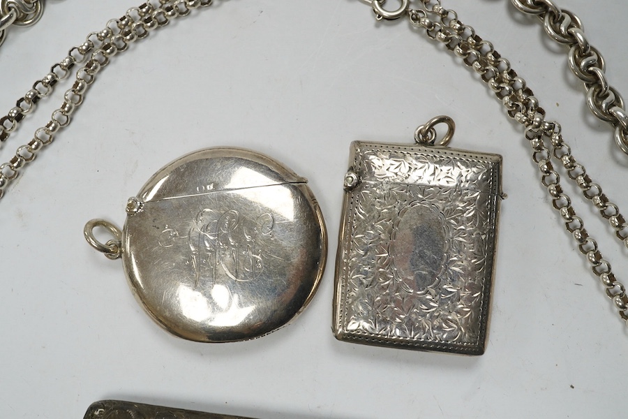 An Edwardian engraved silver sovereign case, Birmingham, 1905, on a silver chain, one other sterling chain, two silver vesta cases and a silver card case. Condition - poor to fair